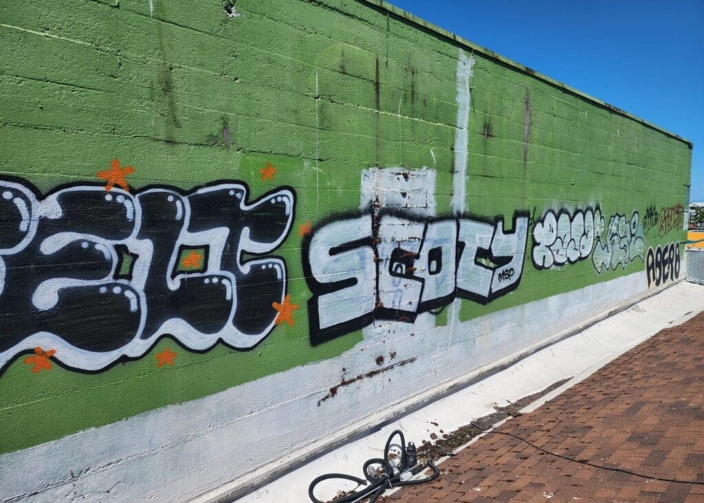 Colorful graffiti on green wall.