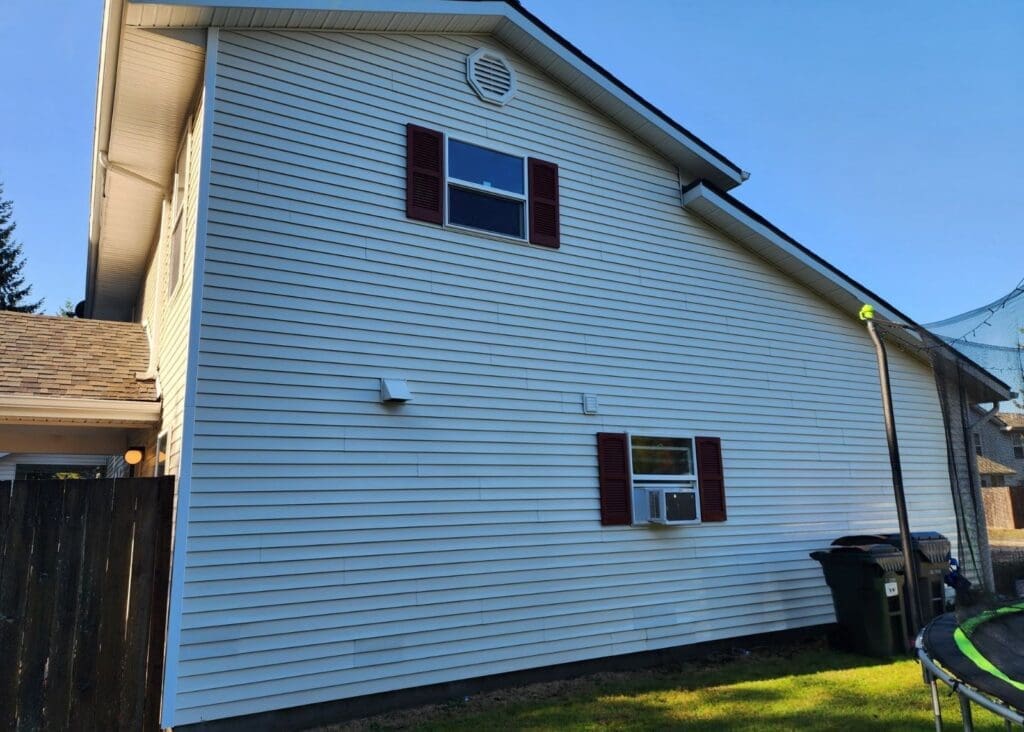 White house with red shutters and lawn