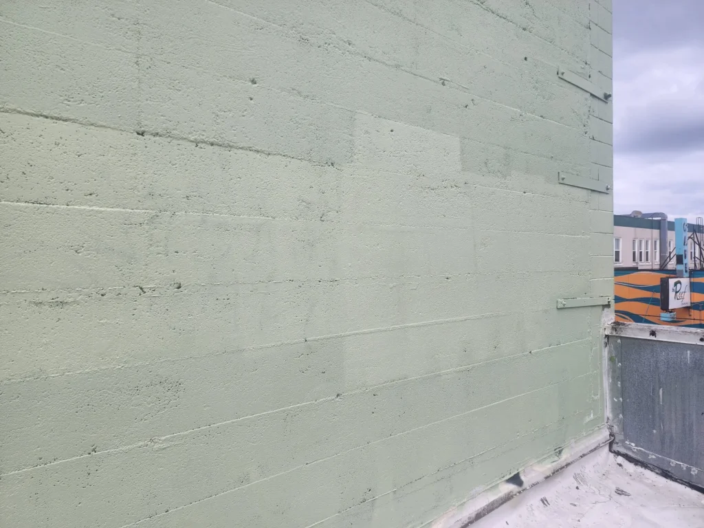 Plain green wall with minimal texture.